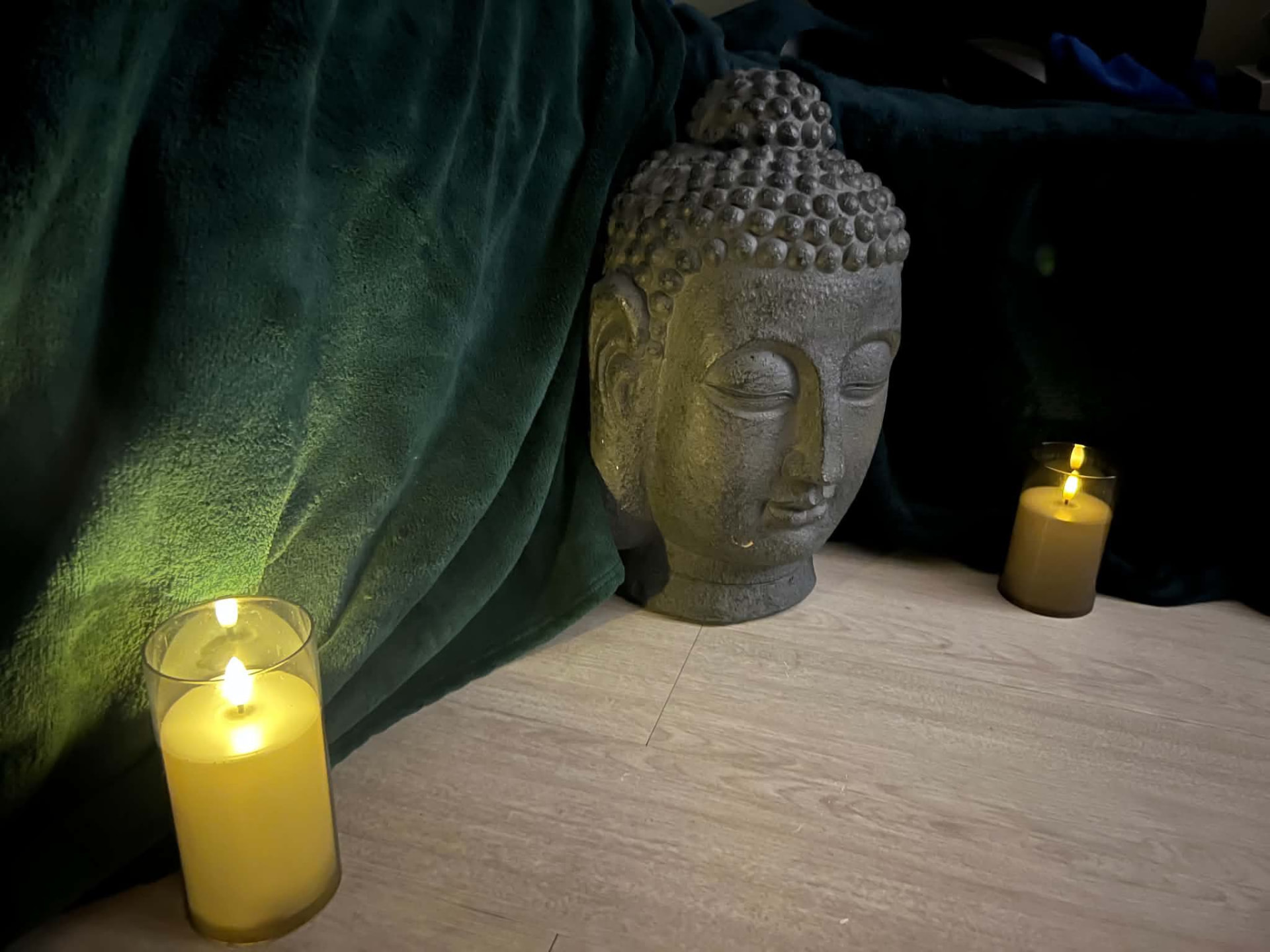 Buddha head and candlelight in the treatment studio